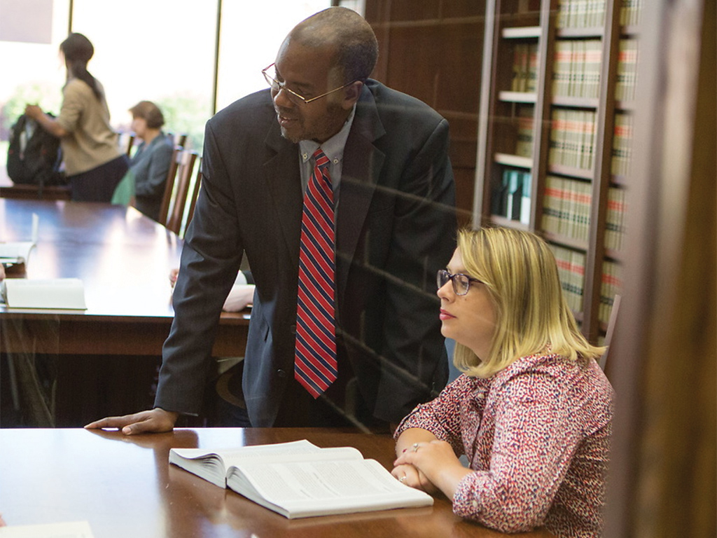 Dr. Jean-Marie Kamatali working with a law student.