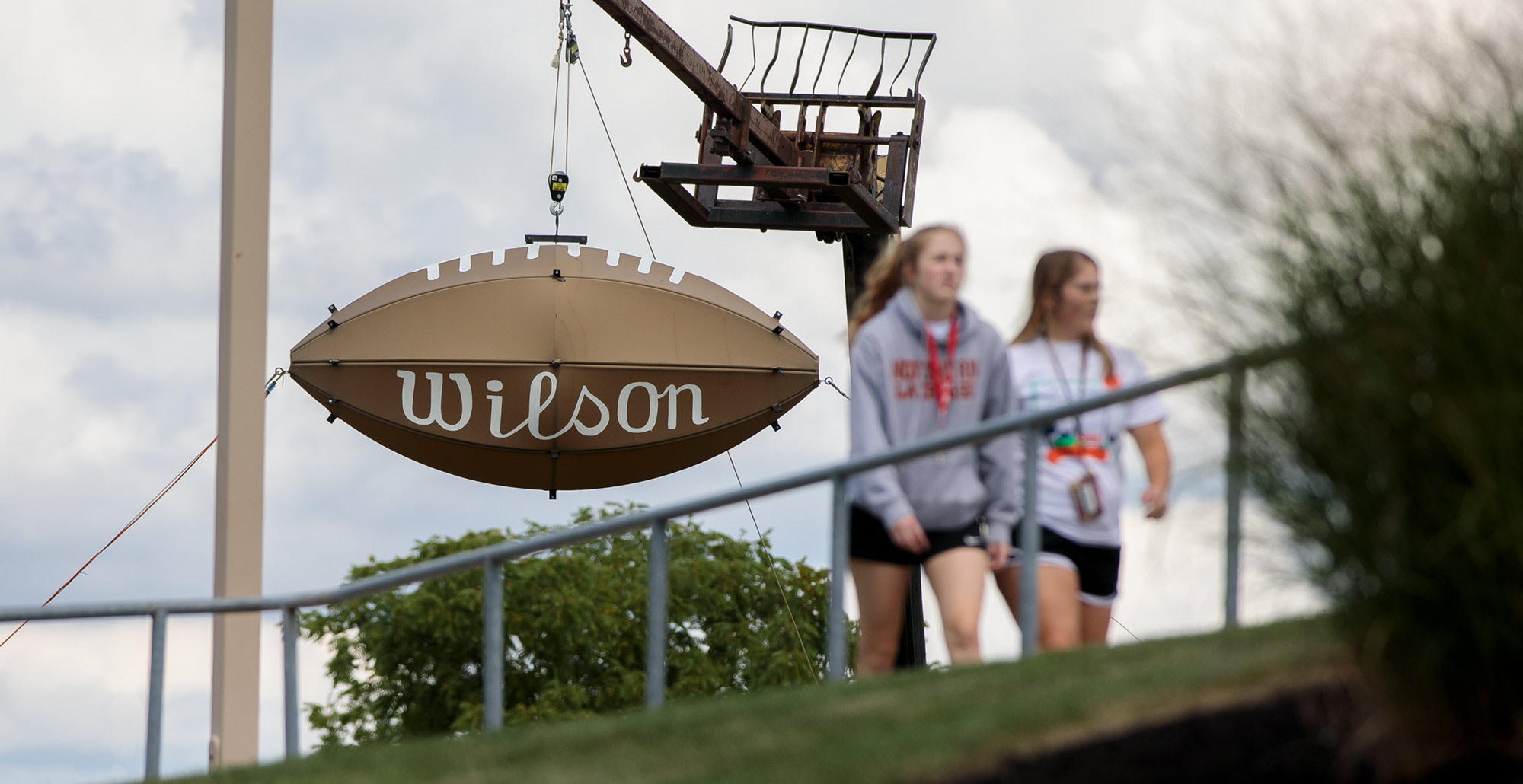 Students walk past the giant Wilson football outside of Dial-Roberson Stadium on the campus of Ohio Northern University.