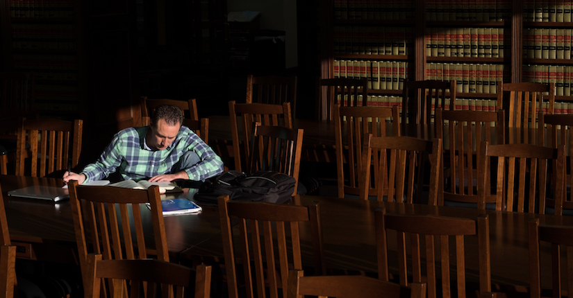 student studying in law library