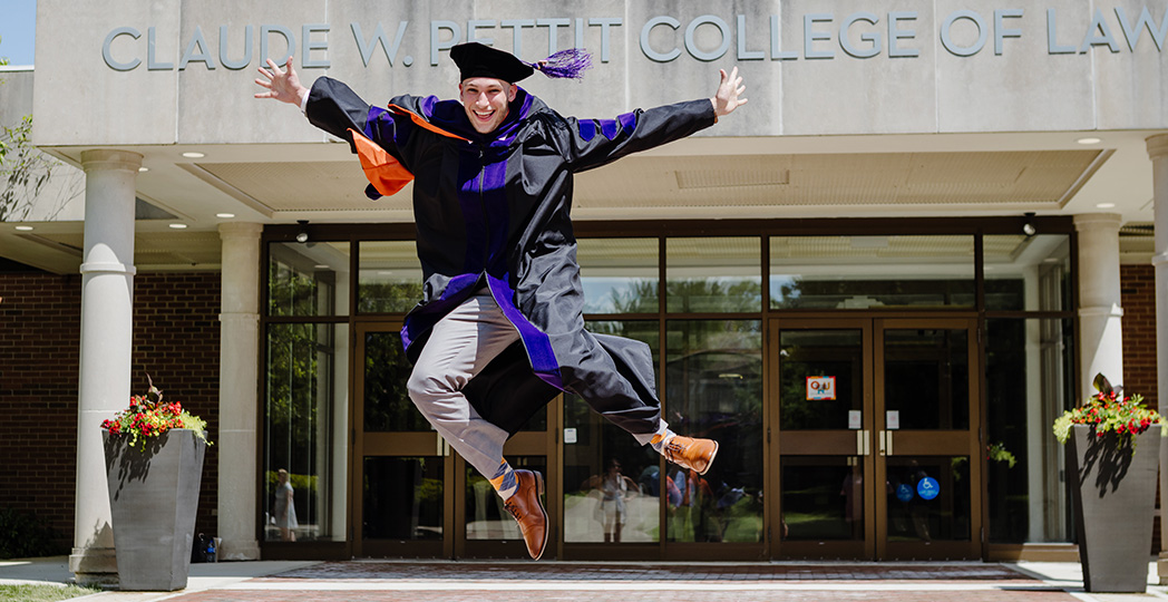 graduate jumping for joy