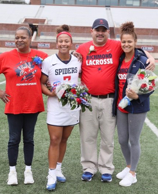 Photo of Tatiana Monds with family on the field