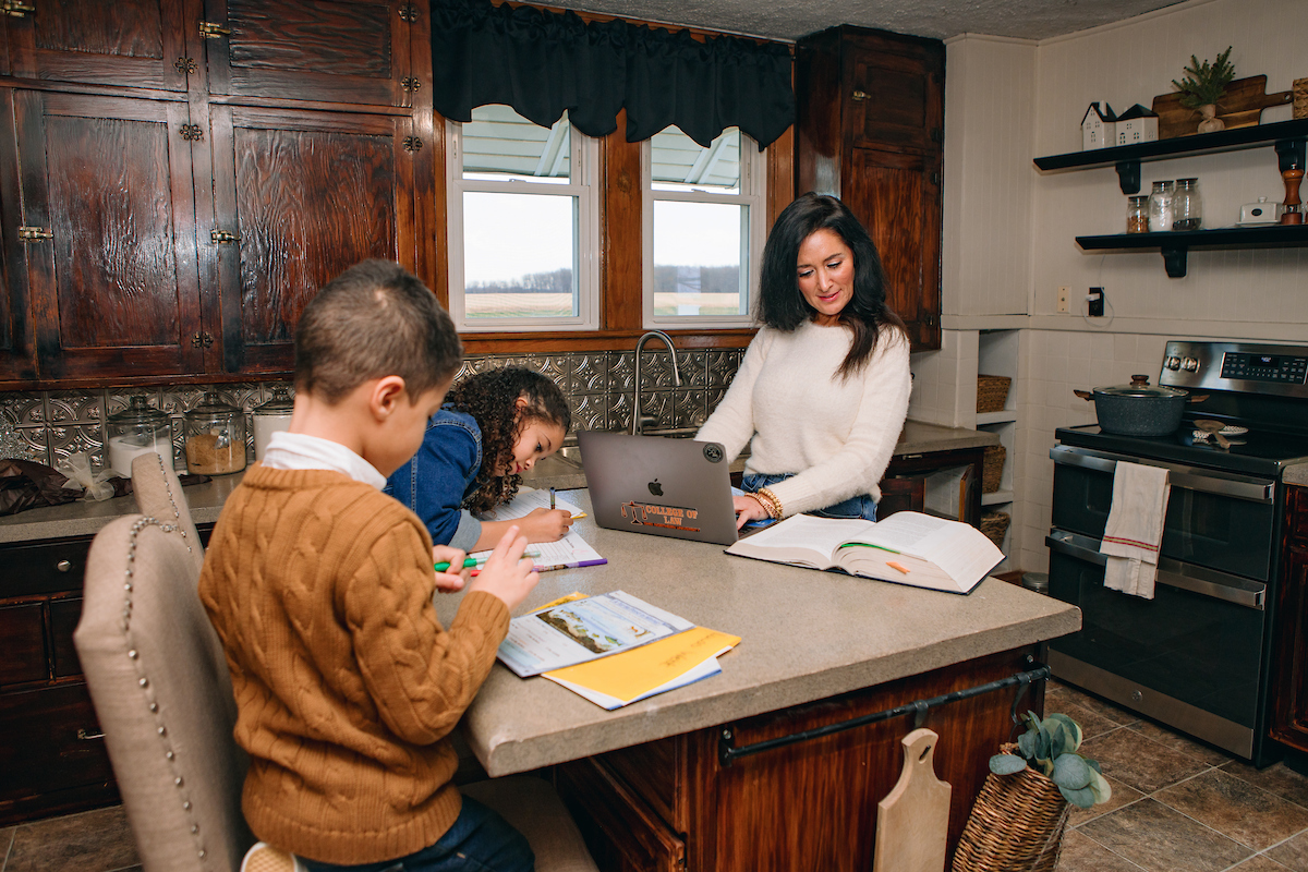 Law Student working online at her home with her two children