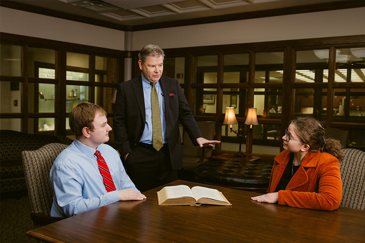 3 ONU people in a law conference room discussing