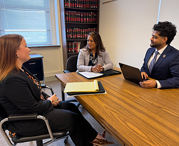 Ohio Northern University law student meeting with clients to discuss legal matters.
