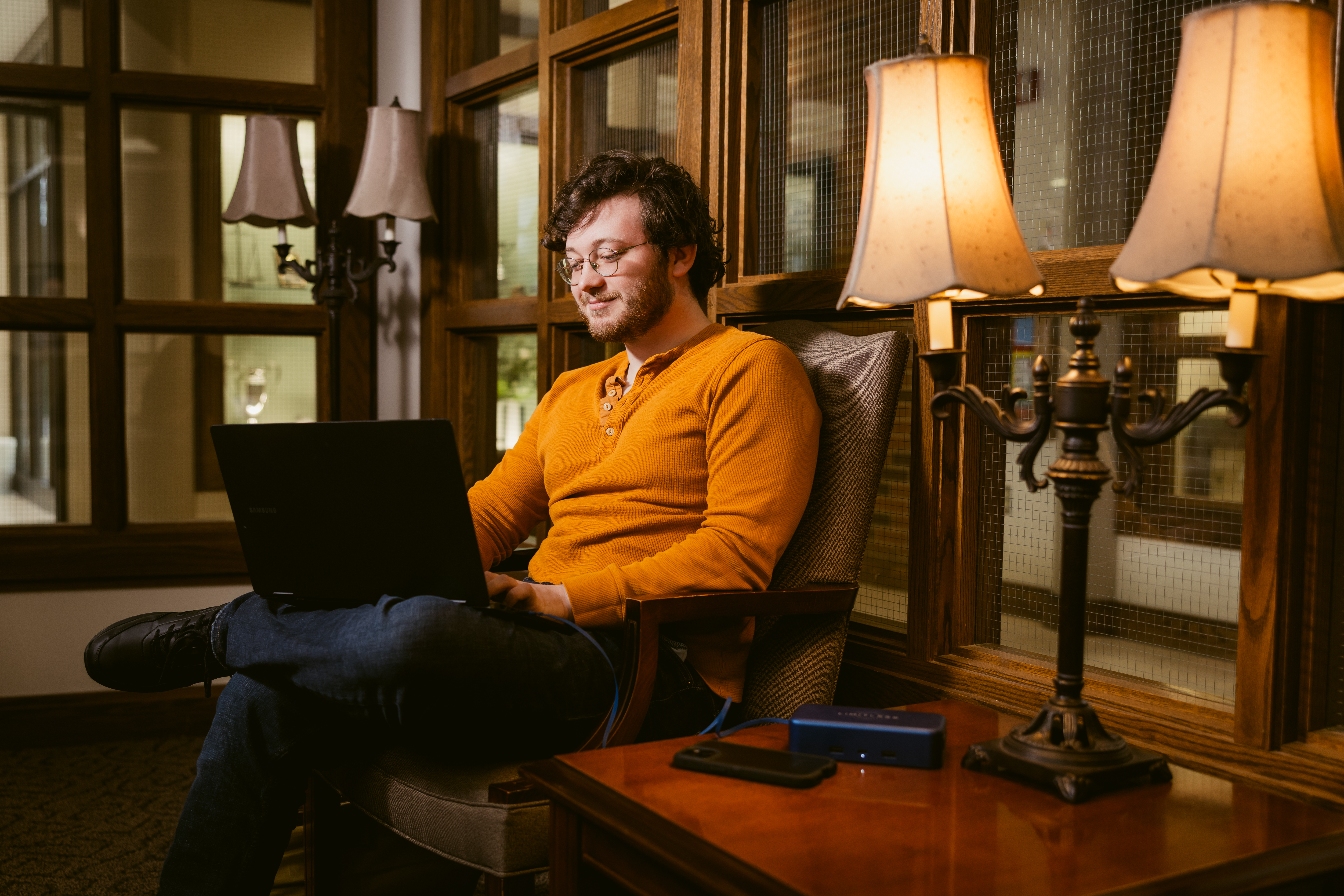 student studying in formal lounge 