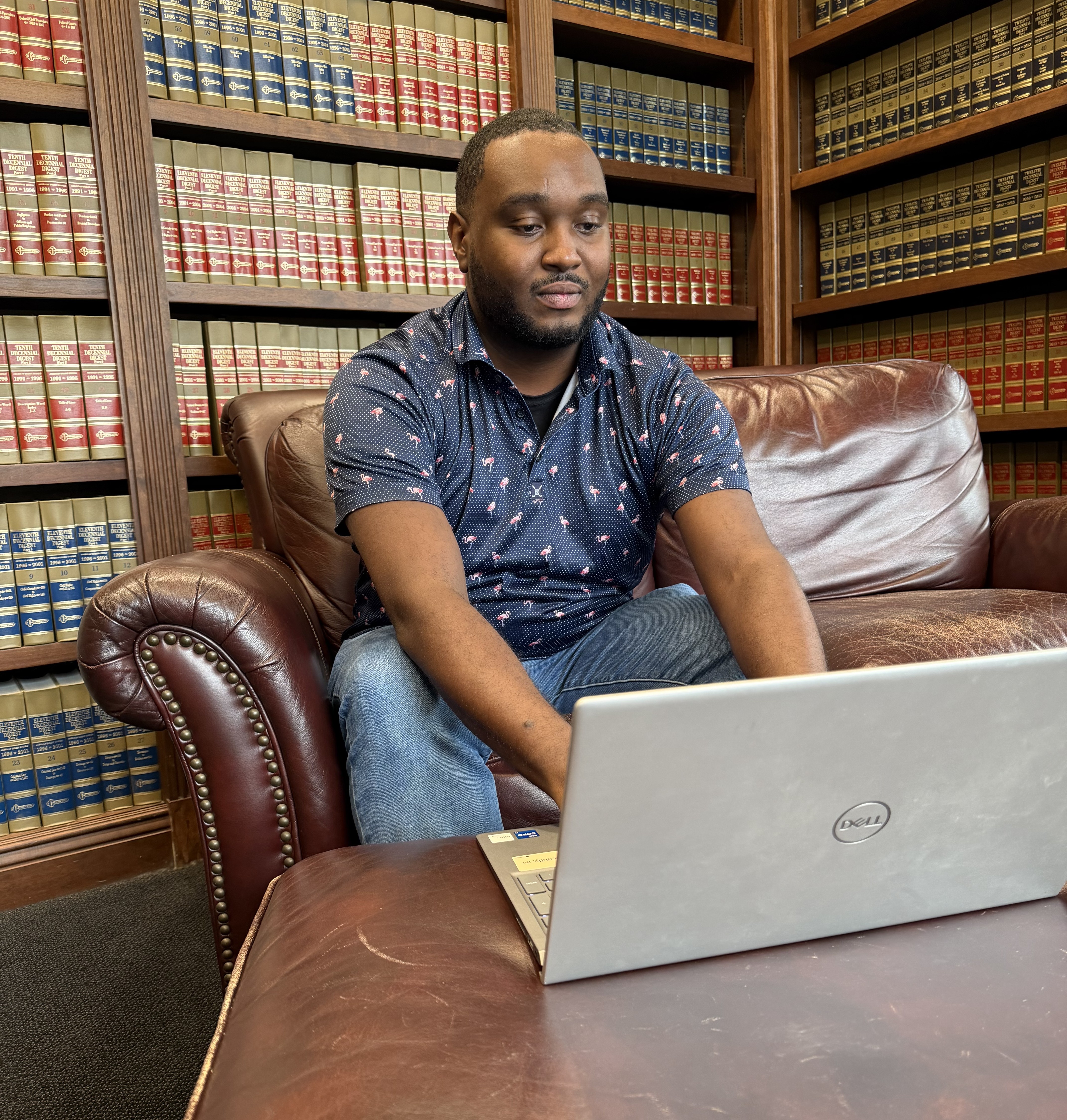 student working on computer in law library