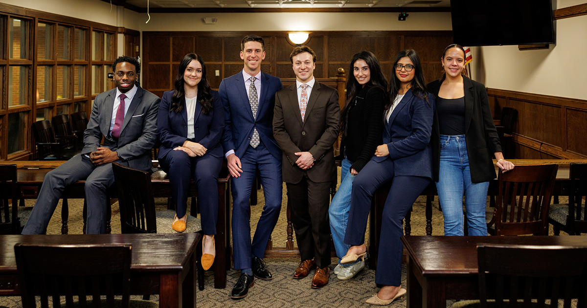 A group of law students sitting together in a courtroom setting